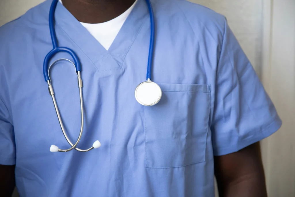 Medical professional in blue scrubs with a stethoscope representing CIWA alcohol withdrawal monitoring in Orange County
